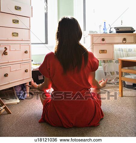 Woman in red robe sitting on floor meditating in lotus pose View Large Photo Image Stock Photograph - Woman in red robe sitting on floor meditating in lotus pose. Fotosearch