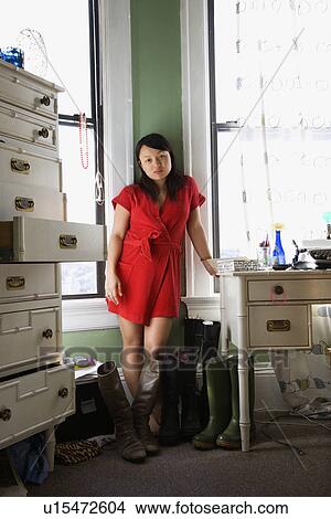 Woman standing in red robe in bedroom View Large Photo Image Picture - Woman standing in red robe in bedroom. Fotosearch