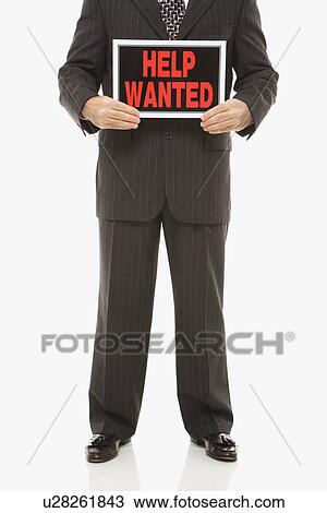 Stock Image - Businessman holding help wanted sign. Fotosearch