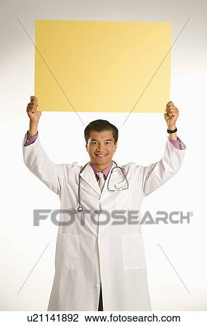 Doctor holding blank sign View Large Photo Image Stock Image - Doctor holding blank sign. Fotosearch
