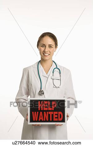 Doctor holding up help wanted sign View Large Photo Image Stock Image - Doctor holding up help wanted sign. Fotosearch
