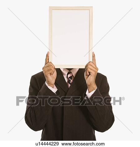 Man holding blank sign over his face standing against white background View Large Photo Image Stock Photo - Man holding blank sign over his face standing against white background. Fotosearch