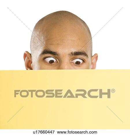 Man peeking over blank yellow sign View Large Photo Image Stock Photo - Man peeking over blank yellow sign. Fotosearch