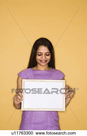 Stock Image - Woman holding blank sign. Fotosearch