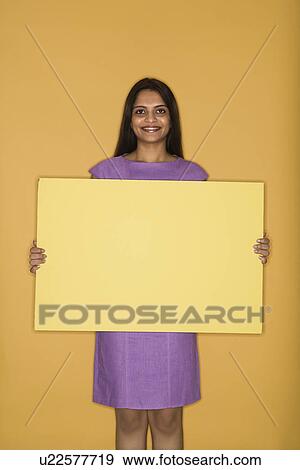 Woman holding blank sign View Large Photo Image Stock Photo - Woman holding blank sign. Fotosearch