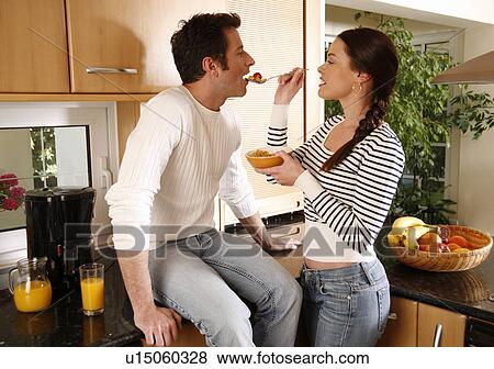 Stock Photo - A young couple eating breakfast. Fotosearch