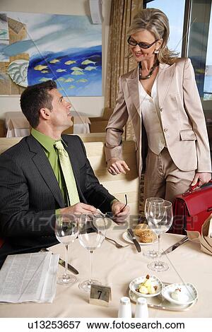 Stock Photo - Businessman and businesswoman meeting in a restaurant. Fotosearch