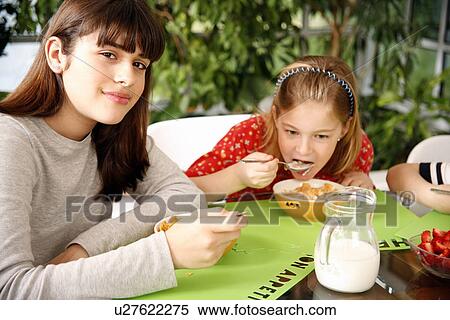 Children eating breakfast View Large Photo Image Stock Photography - Children eating breakfast. Fotosearch