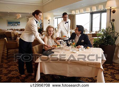 Stock Photo - Couple being served in a restaurant. Fotosearch