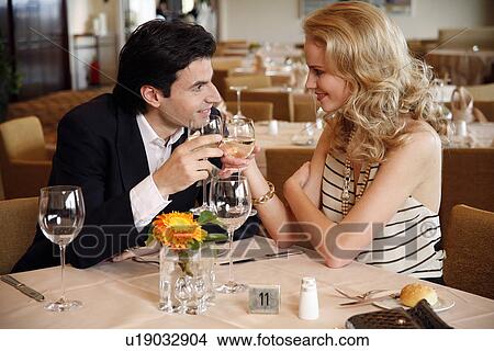Couple having a romantic moment in a restaurant View Large Photo Image Picture - Couple having a romantic moment in a restaurant. Fotosearch