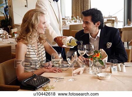 Couple having a romantic moment in a restaurant View Large Photo Image Stock Photo - Couple having a romantic moment in a restaurant. Fotosearch