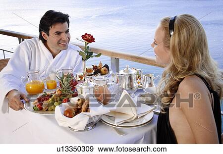 Couple having breakfast on hotel terrace View Large Photo Image Stock Photo - Couple having breakfast on hotel terrace. Fotosearch