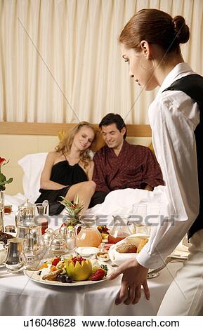 Stock Photo - Couple having breakfast on hotel terrace. Fotosearch
