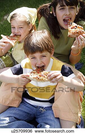 Stock Photograph - Three children eating pizza. Fotosearch