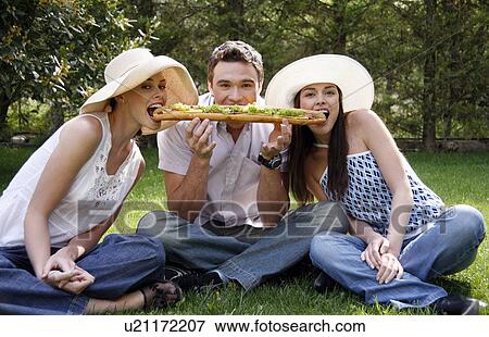 Three friends sharing a big sandwich View Large Photo Image Stock Photo - Three friends sharing a big sandwich. Fotosearch