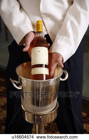 Waiter displaying wine bottle View Large Photo Image Picture - Waiter displaying wine bottle. Fotosearch
