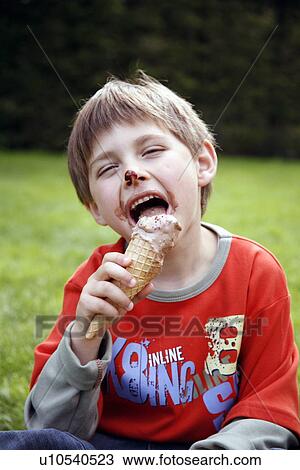 Young boy eating ice cream View Large Photo Image Stock Image - Young boy eating ice cream . Fotosearch