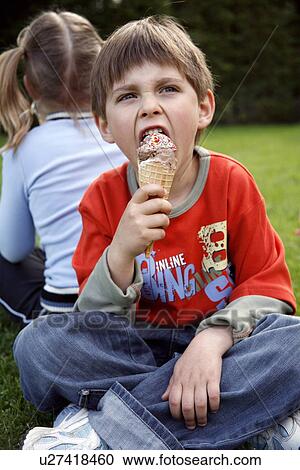 Stock Image - Young boy eating ice cream . Fotosearch