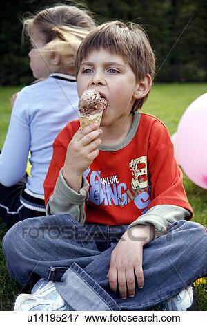 Young boy eating ice cream View Large Photo Image Stock Photo - Young boy eating ice cream . Fotosearch