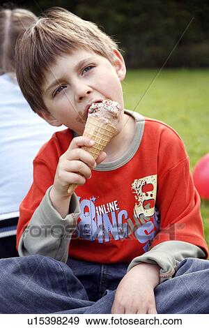 Young boy eating ice cream View Large Photo Image Stock Photo - Young boy eating ice cream . Fotosearch
