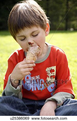 Young boy eating ice cream View Large Photo Image Stock Photo - Young boy eating ice cream . Fotosearch