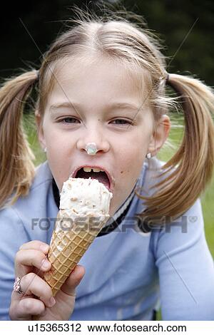 Young girl eating ice cream View Large Photo Image Stock Image - Young girl eating ice cream . Fotosearch