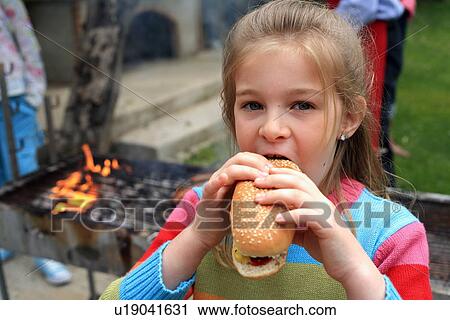 Young girl eating ice cream View Large Photo Image Stock Image - Young girl eating ice cream . Fotosearch