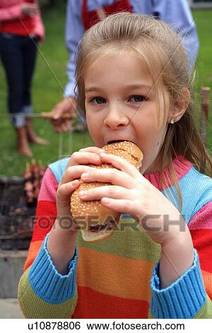Young girl eating ice cream View Large Photo Image Stock Photograph - Young girl eating ice cream . Fotosearch