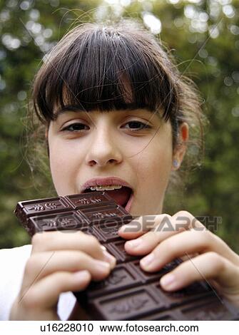 Young teenage girl eating chocolate View Large Photo Image Stock Image - Young teenage girl eating chocolate. Fotosearch