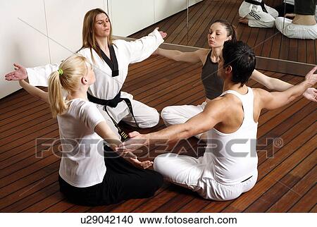 Participants in a fitness class practicing breathing exercises View Large Photo Image Stock Image - Participants in a fitness class practicing breathing exercises. Fotosearch