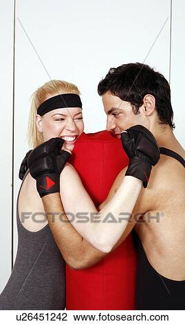 Young man and woman flirting in a fitness class View Large Photo Image Stock Image - Young man and woman flirting in a fitness class. Fotosearch