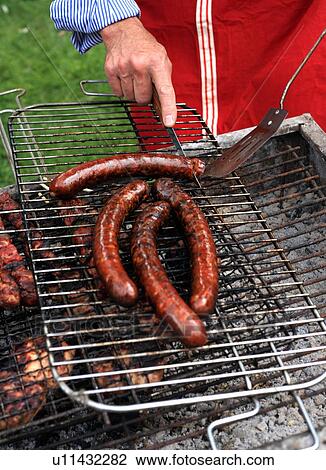 Mature man cooking food at a barbecue View Large Photo Image Stock Image - Mature man cooking food at a barbecue. Fotosearch