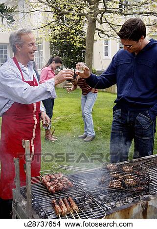 Picture - Men drinking at a barbecue. Fotosearch