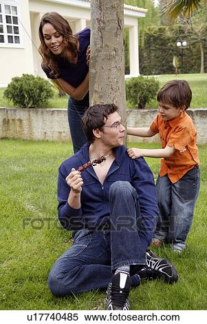 Stock Photography - Parents and child playing in the yard. Fotosearch