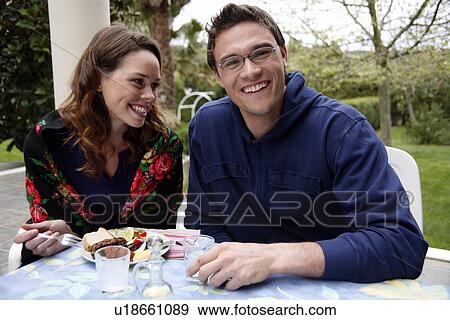 Stock Photo - Young couple eating. Fotosearch