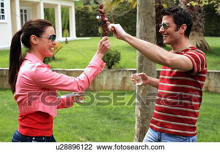 Young couple playing with souvlaki View Large Photo Image Stock Image - Young couple playing with souvlaki. Fotosearch