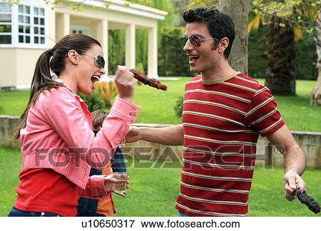 Young couple playing with souvlaki View Large Photo Image Stock Photo - Young couple playing with souvlaki. Fotosearch