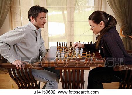 Stock Image - A man and woman playing chess. Fotosearch