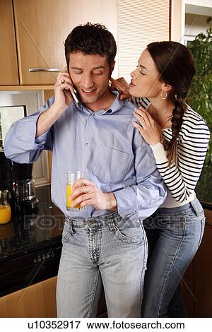 Stock Photo - A young couple in the kitchen. Fotosearch