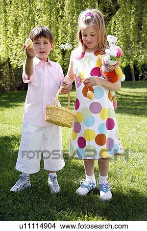 Picture - Boy and girl playing in the yard. Fotosearch
