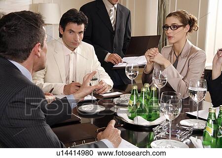 Business people sitting at a conference table View Large Photo Image Stock Image - Business people sitting at a conference table. Fotosearch