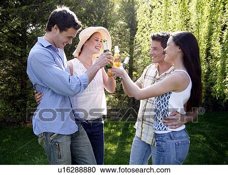 Stock Image - Group of friends drinking beer. Fotosearch