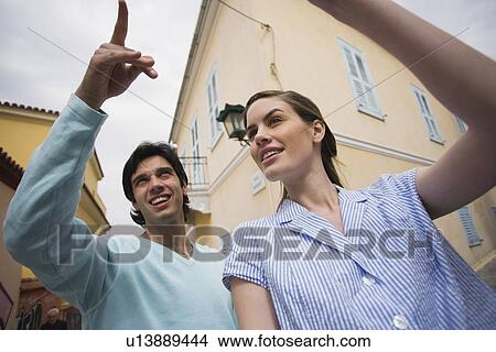 Man and woman pointing View Large Photo Image Picture - Man and woman pointing. Fotosearch