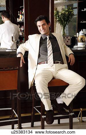 Picture - Man sitting at a bar . Fotosearch