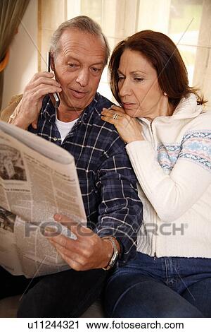 Stock Image - Mature couple relaxing at home. Fotosearch