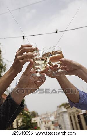 People's hands toasting with white wine View Large Photo Image Stock Photography - People's hands toasting with white wine. Fotosearch
