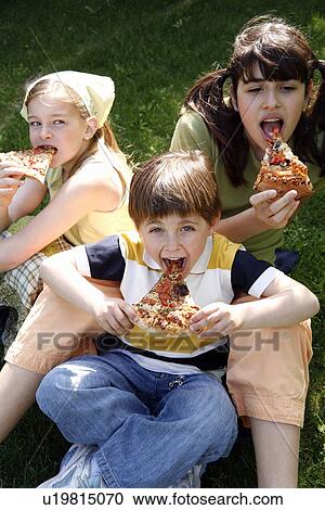 Three children eating pizza View Large Photo Image Stock Image - Three children eating pizza. Fotosearch