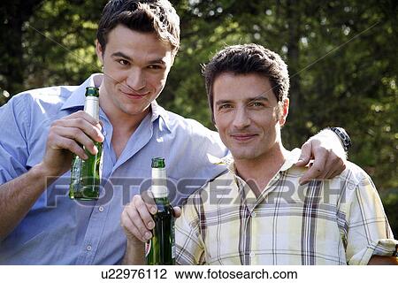 Stock Image - Two men drinking beer. Fotosearch