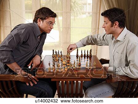 Stock Image - Two men playing chess. Fotosearch