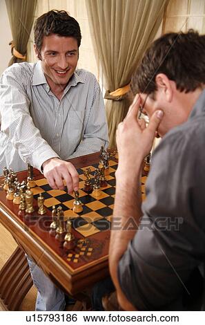 Stock Photograph - Two men playing chess. Fotosearch